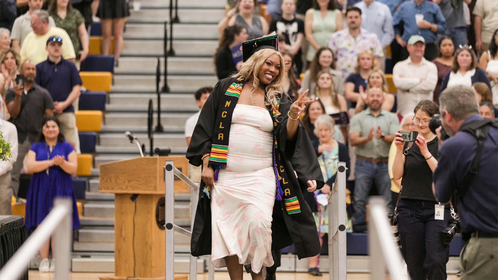 A MCLA first generation student smiling at commencement.