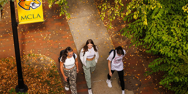 Three MCLA students walking on campus