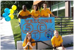 Students holding a Welcome STEM sign